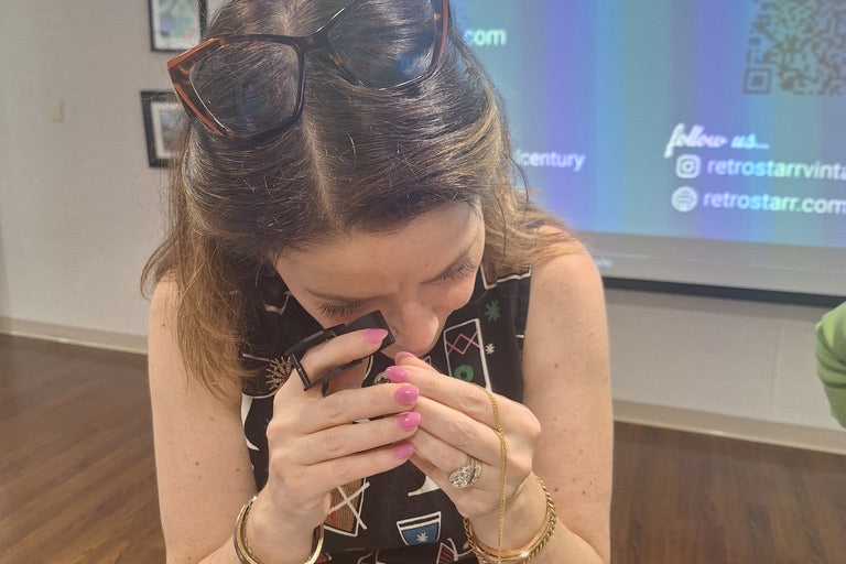 Woman in a patterned dress holding her face in front of a screen displaying 'Retro Star'.
